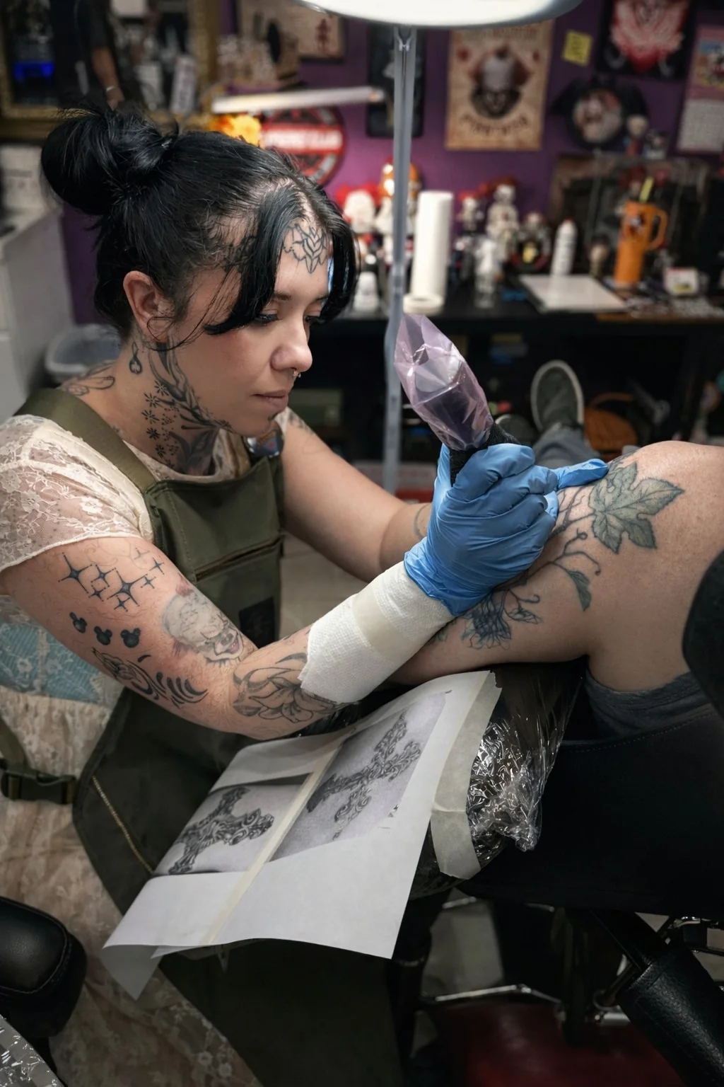 Tricky Lake tattooing a client